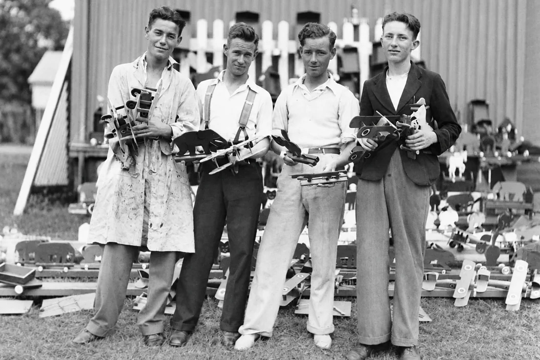 The same 1934 group photo after restoration, with the cracks removed and the faces unchanged