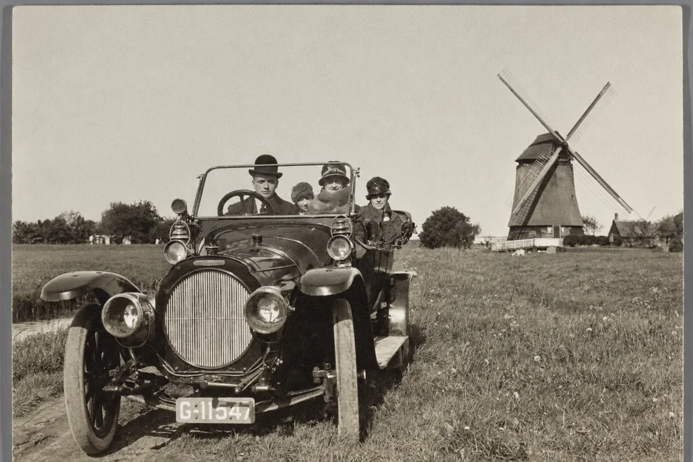 The same car and windmill photo after restoration, with the stain removed and neutral tones